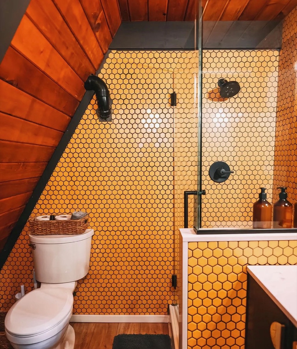 Compact bathroom fitted within an A-frame cabin