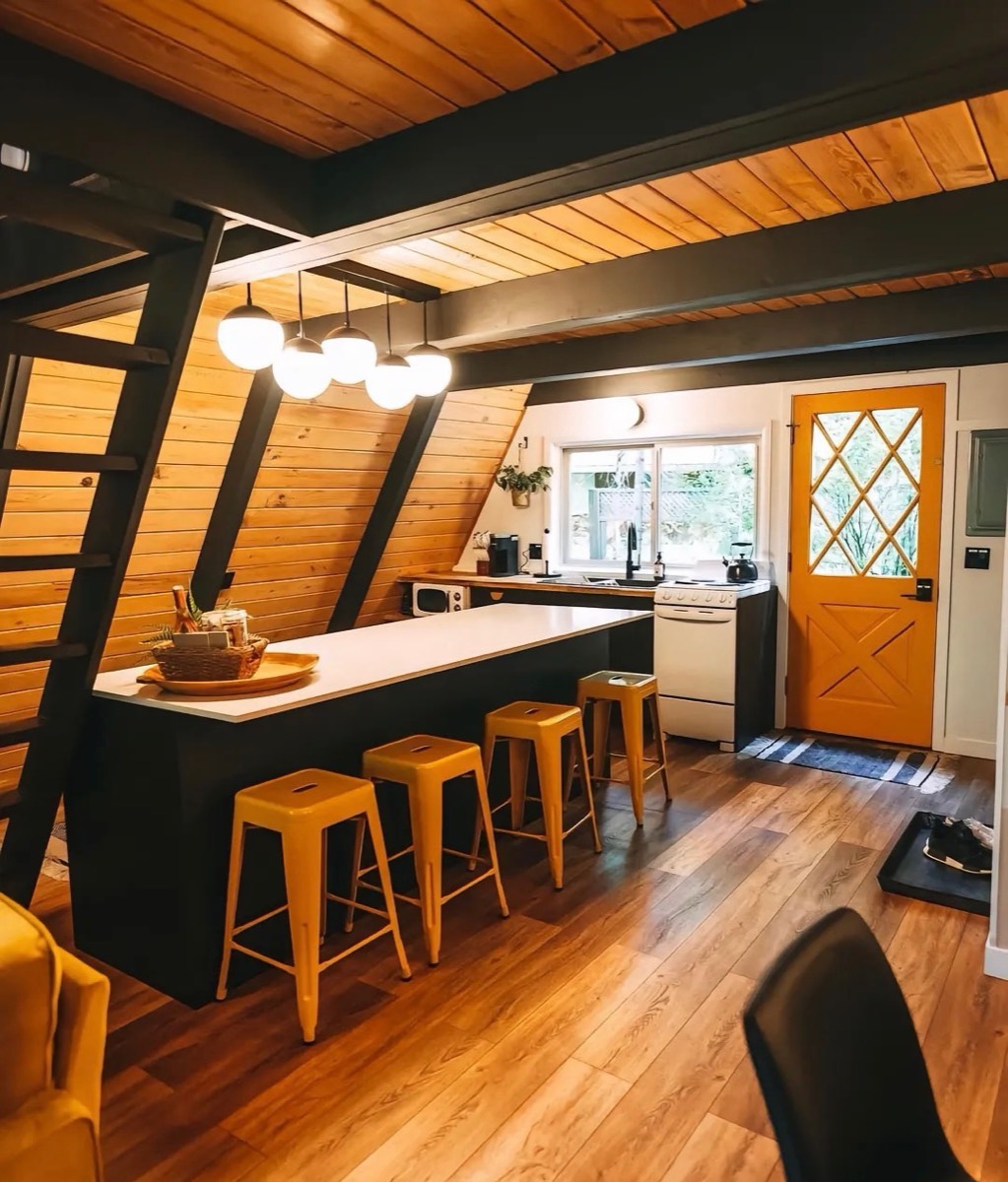 Fitted kitchen inside a compact A-frame cabin