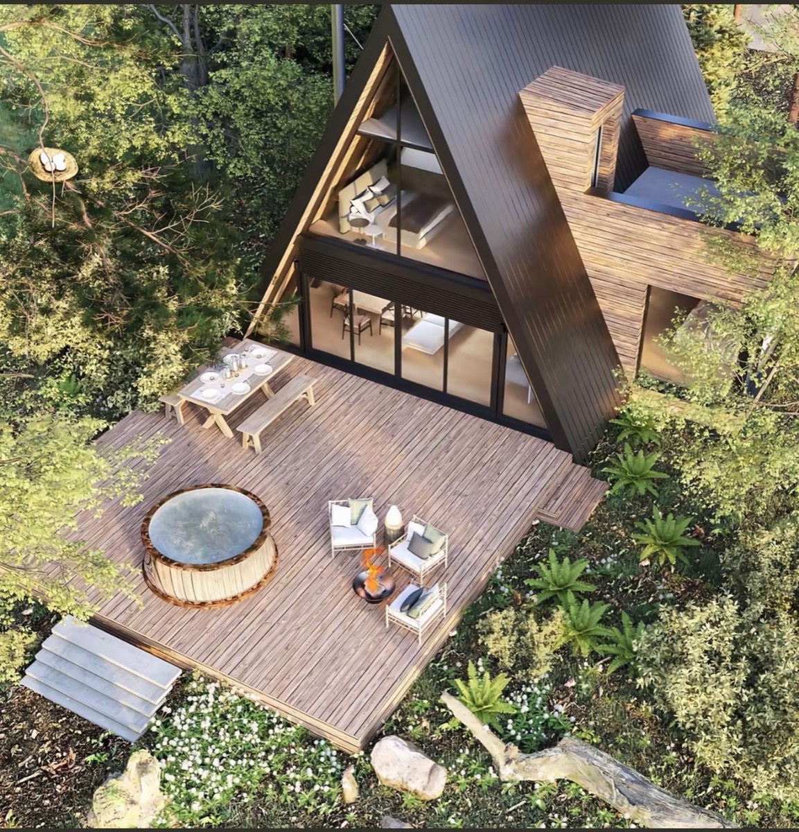 Aerial view of an A-frame cabin with a large deck
