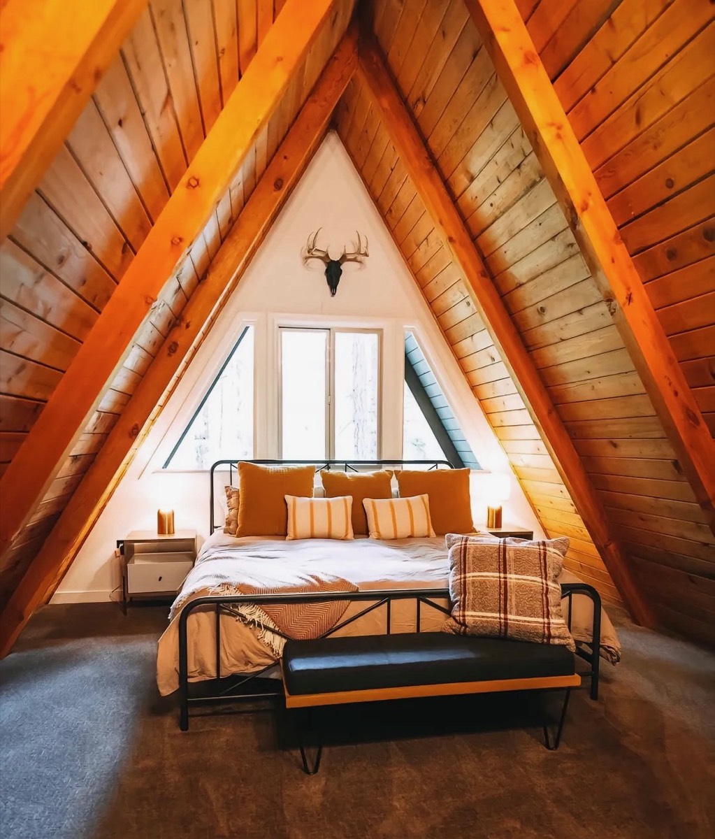 Double bedroom beneath an A-frame timber roof