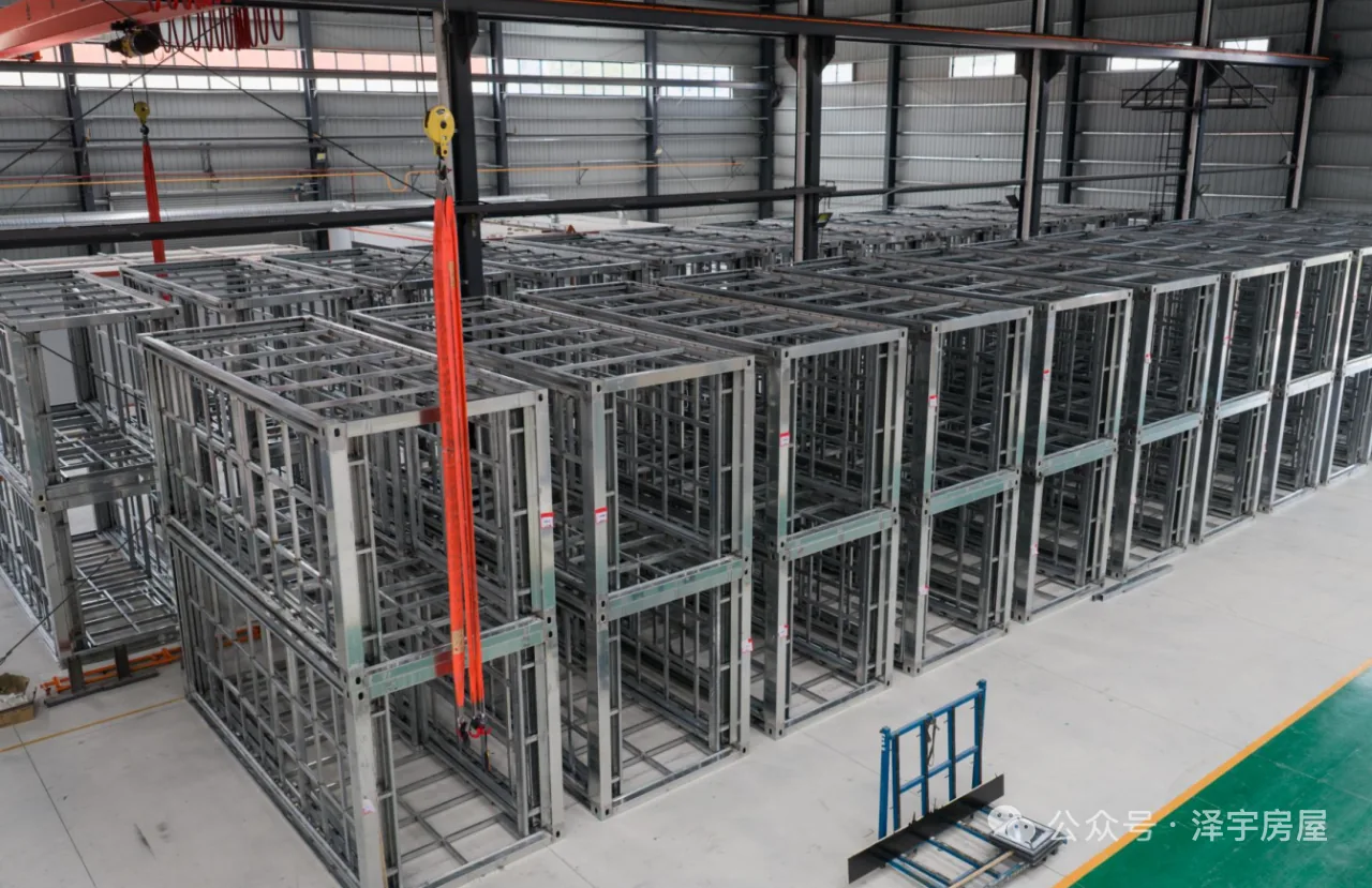 Rows of galvanized expandable house frames stored inside the factory