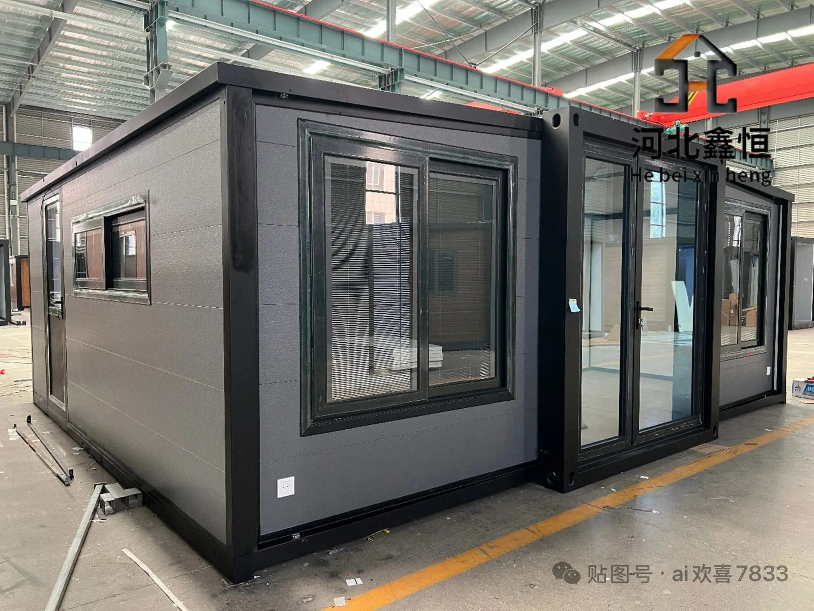 Custom dark grey expandable house exterior with windows and glazed entrance