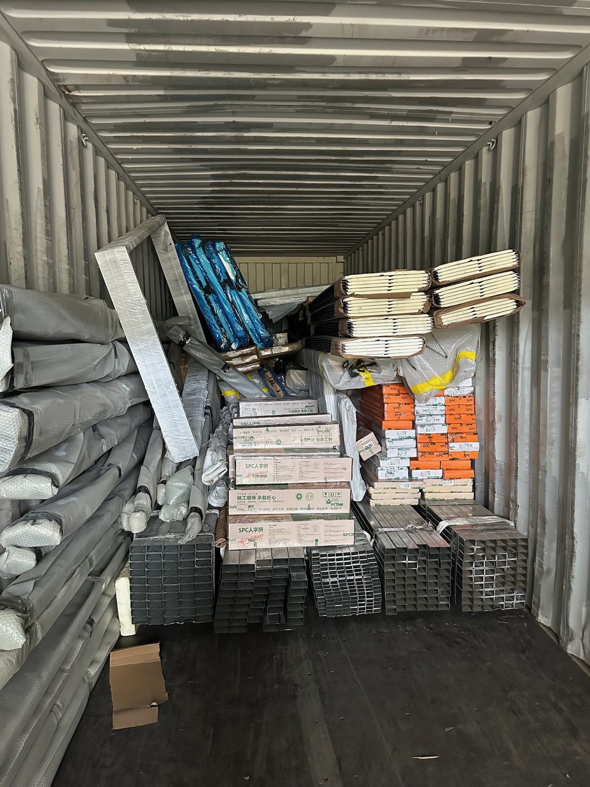 Steel framing and modular house components packed inside a container
