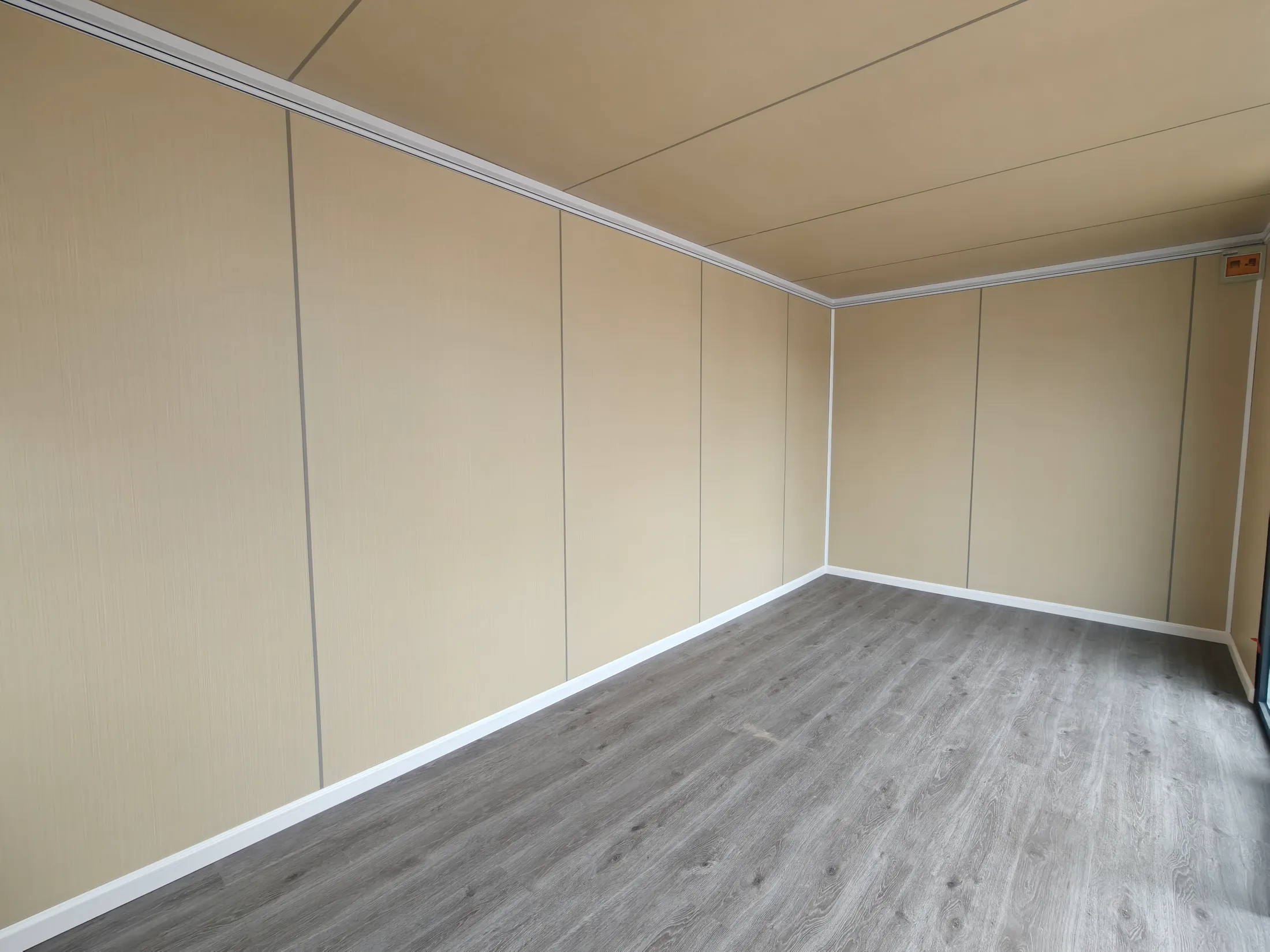 Wide finished interior of an unfurnished apple cabin