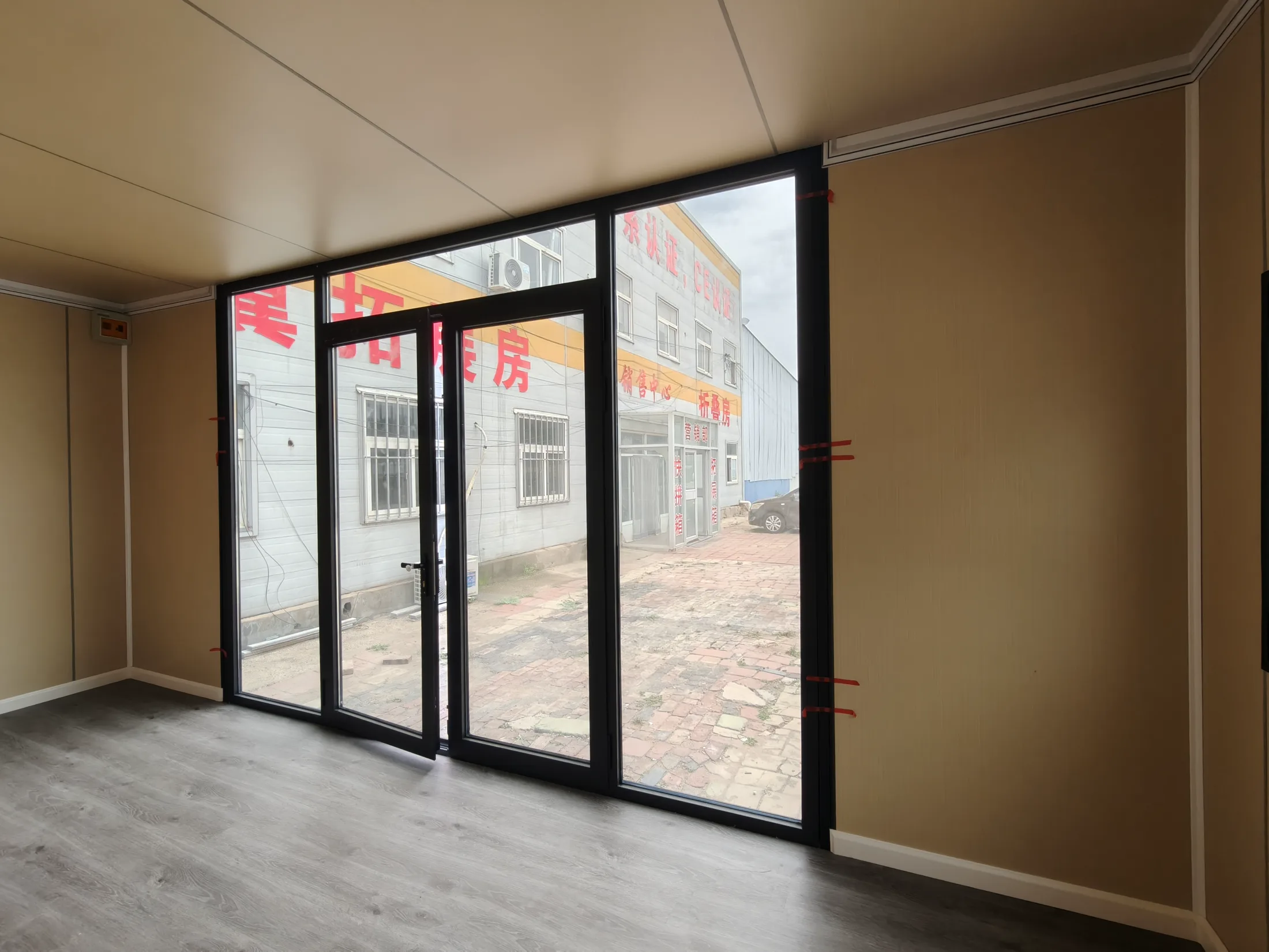 View from inside an apple cabin toward the panoramic glazed entrance