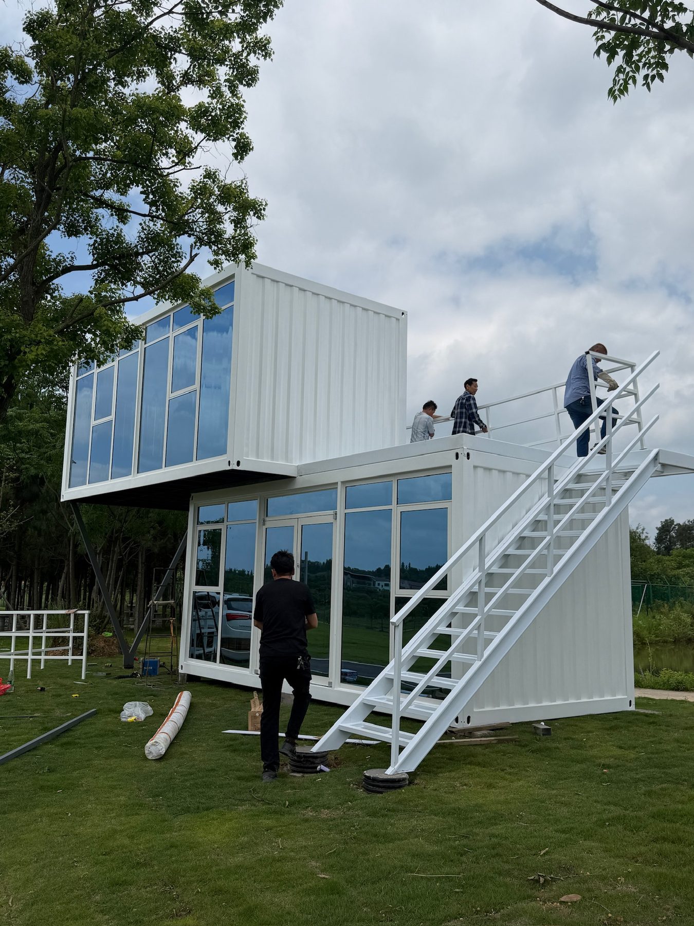 Two-storey modular house exterior with upper-level access