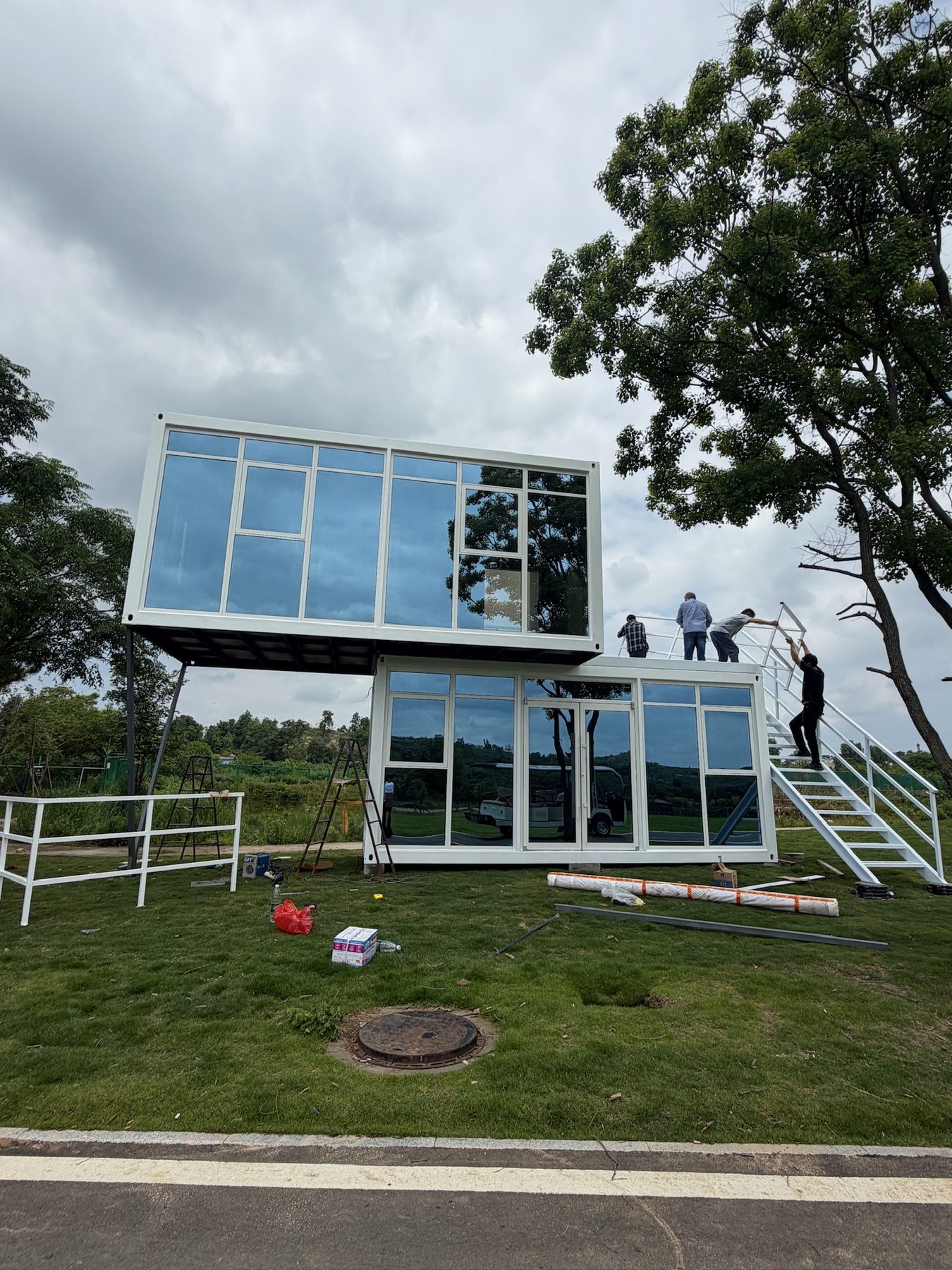 Two-storey modular house installed on a landscaped site